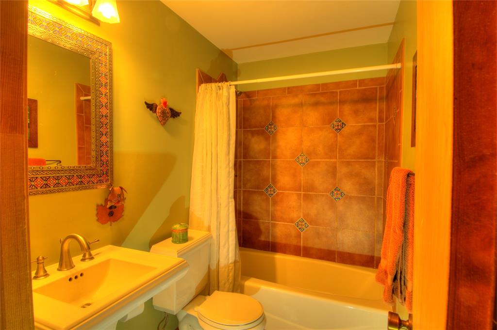 This is the guest bathroom and features and tub/shower combo with Mexican tiles.