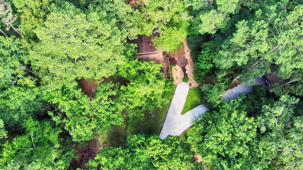 An aerial view of the property showing the shade trees and privacy that ~2.4 acres provides