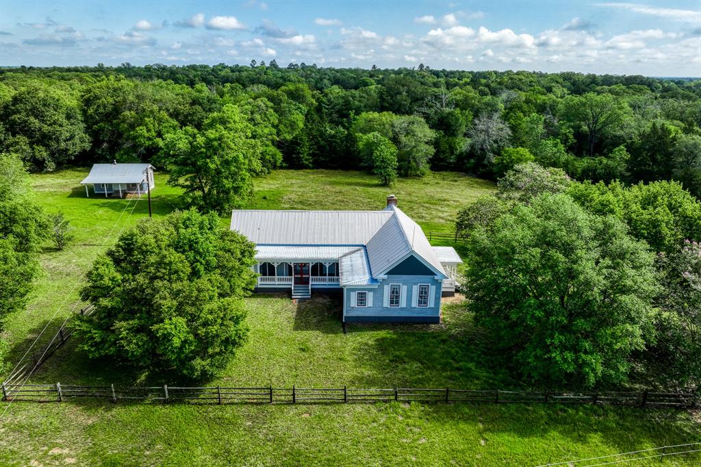 This lovely 62.910 acre ranch has been enjoyed by five generations of a pioneer Texas family and is offered for sale for the first time in over 110 years. Located just two miles east of historic New Ulm, just 25 minutes to Round Top, and a bit over an hour drive to west Houston, this is a perfect place for weekend getaways, remote work plans. A picturesque 1895 farmhouse, originally built by Anton Heinsohn & relocated to the ranch 30 yrs ago, features tranquil views of the pastures, woods and pond. The 1500 sf house has 2 bdms/2 baths & porches in front and back. Sold turn key, the house is furnished with period Texas furniture purchased over the years at the Round Top Antique Shows. Decor includes charming original stenciling, shiplap walls/ceilings & original pine floors. The ranch enjoys a mix of dense woods to explore and rolling pastures perfect for horses or cattle and is said to trace its roots back to the original Steven F. Austin land grant from Mexico.