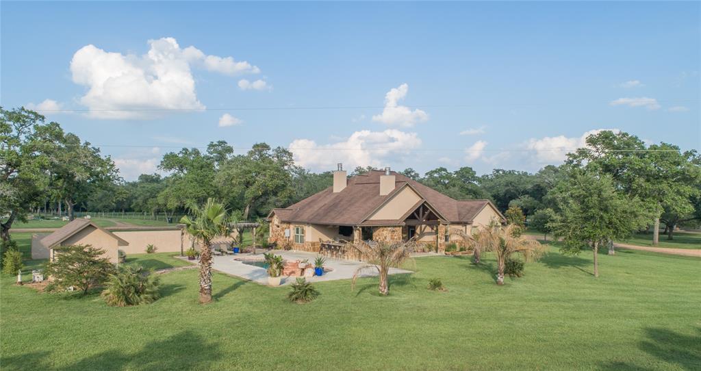 Located on 9.809 acres, this exquisite & well maintained equestrian ranchette features a 2,268 sq ft Ken Richter custom built home along w/ a three-stall horse barn & a 2,400+/- sq ft shop. The beautiful 3 bedroom, 2 1/2 bath home comes w/ all of the upgrades one could desire. The house exudes beauty & elegance w/ its cathedral ceiling, granite counter tops, custom knotty elder cabinets, handmade apron copper sink, hard wood floors/travertine tile throughout, thermado appliances, custom wood barn doors, custom wood turquoise inlayed fireplace mantle & so much more. Step outside & you can watch the horses frolic in the paddock while relaxing in the pool, cooking in the outdoor kitchen or relaxing by the outdoor fireplace. The custom 36x36 horse barn offers 3 full size stalls, tack room, wash rack & hay storage. The 2,400+/-sq ft shop has a commercial grade AC/heat, kitchen & bathroom, (3) 14x14 garage doors & lean-two. The property boasts 2 water wells, 2 septic's & 2 RV hookups.