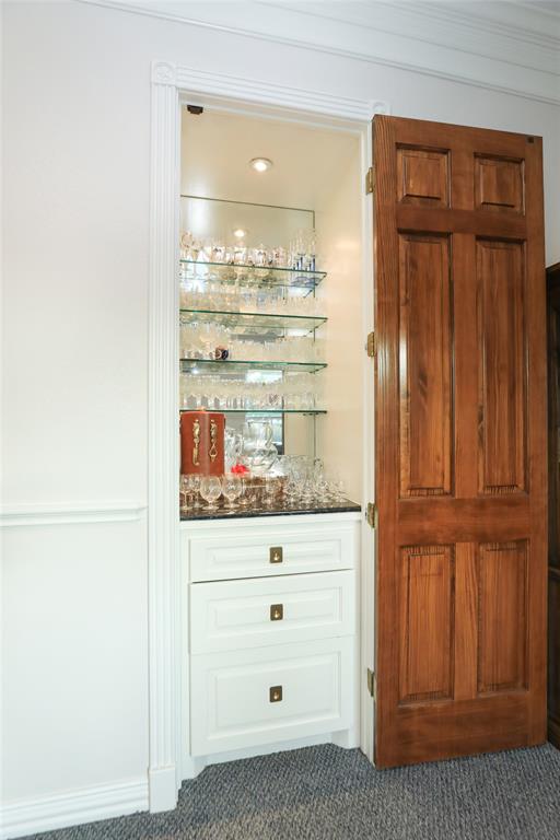 Dry bar with plenty of space to display glassware and drawers for accessories.