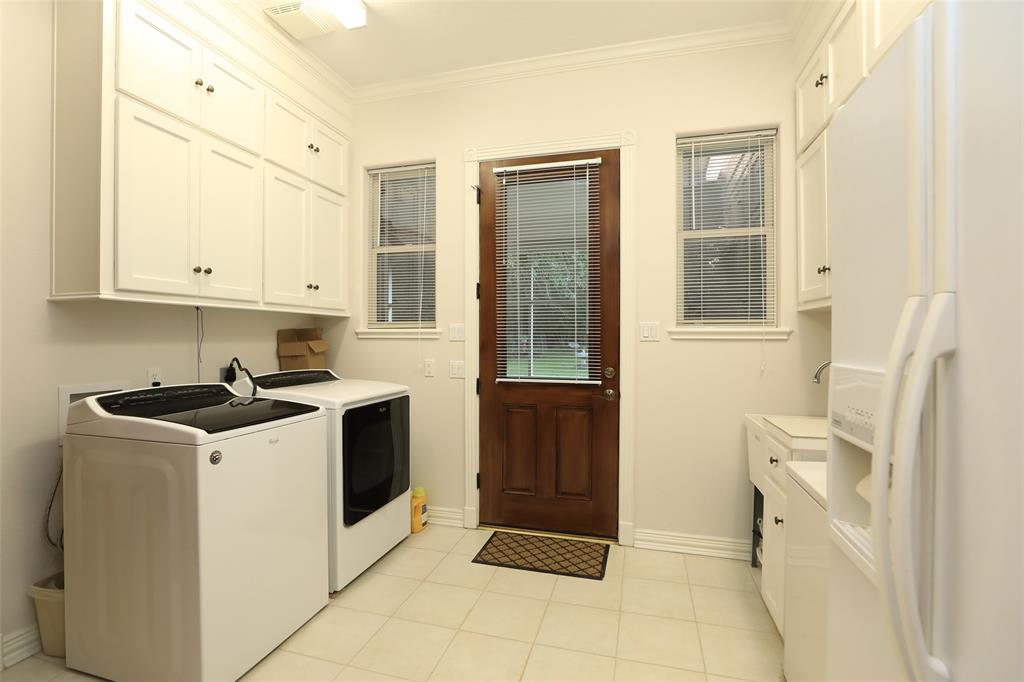Utility room has plenty of space for extra refrigerator and chest deep freeze in addition to a washer and dryer. Plenty of storage space.