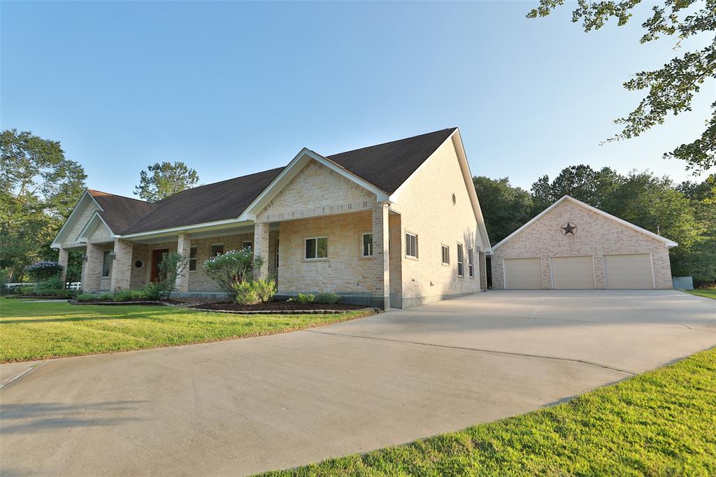 Large 3 car garage. Electric point for battery charging and central vac outlet by each car. Covered breezeway from back door to garage and workshop.