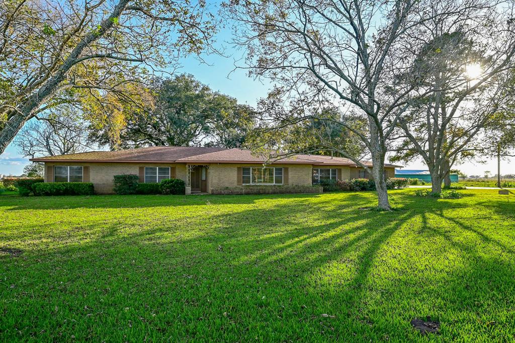 Custom built ranch home surrounded by mature live oaks and grafted pecan trees.  Two living areas!!  The house has 3 bedrooms with 2-1/2 bathrooms.  The game room is accessed through the garage and has an additional full bath!   Recent repairs and improvements to the property include: foundation repaired in 2003 by Atlas-Gulf Coast; repainted the interior, new roof, replaced the attic ductwork and painted the barns in 2017; asphalt driveway repaved and the house exterior was repainted in 2018; new underground electric service to the barns and a new front chain-link fence in 2020.  The front half of the property around the homestead is pastureland and the back half of the property is improved (Jiggs) hayfield.  There is an additional water well (well only, no pump) near the gas wells in the hayfield.  Listing Agent, Greg Lapham, is related to the sellers.  All room sizes are approximate and should be verified by the buyer.  GLA to be verified by the buyer.