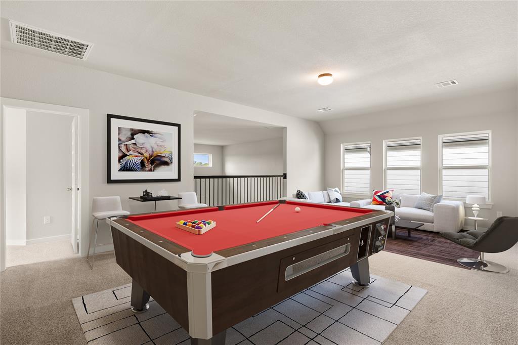 Come upstairs and enjoy a day of leisure in this fabulous game room! This is the perfect hangout spot or adult game room, this space features plush carpet, high ceiling, recessed lighting, custom paint and large windows.