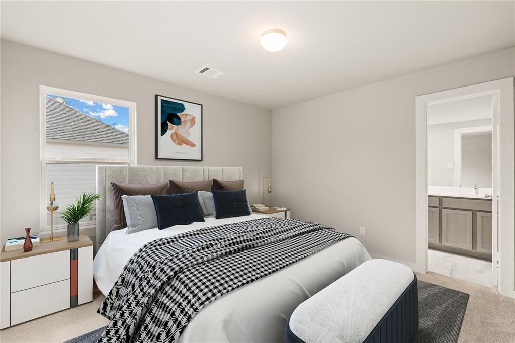 Secondary bedroom features plush carpet, custom paint, large window and access to a private bath.