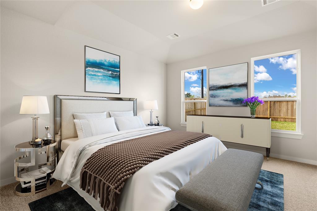 Come and unwind after a long day in this magnificent primary suite! This spacious room features plush carpet, warm paint, high ceilings and large windows.