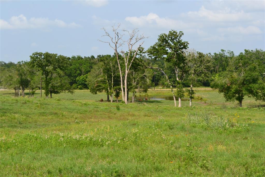 5997 County Road 308 Caldwell, Texas Take a break from the city life at this beautiful 26 acres with hill side views, a spring fed pond stocked with bass and catfish, a 24X28 covered patio and 40X45 barn. The property has cattle working pens, barbed wire perimeter fencing, electricity with meter and water meter onsite. Ag exempt with hard top road frontage and connected to Milam Water Corporation.