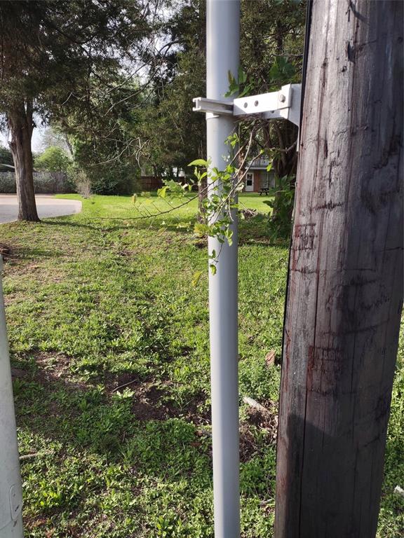 The southwest boundary peg is at the base of the power pole. The ditch follows the west boundary to the back fence.