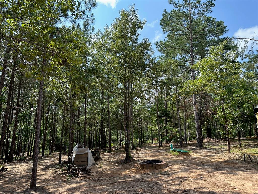 15.05 wooded acres with trails throughout.  There is a beautiful 42' Dutchman camper in place with a very nice deck that overlooks the property.  There is an aerobic septic system and community water in place.  An 18'x12' shop for storing implements is on site also.