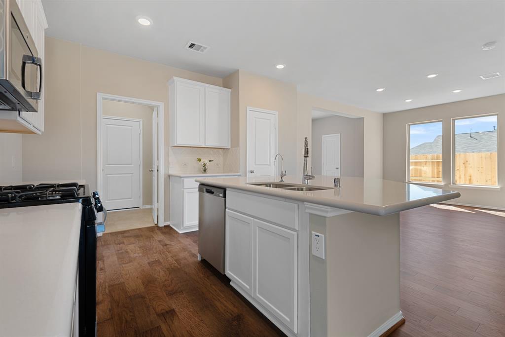 Kitchen opens to laundry room and garage.  Especially nice when you bring in your groceries.  LOTS and lots of cabinets. Stainless steel appliances.