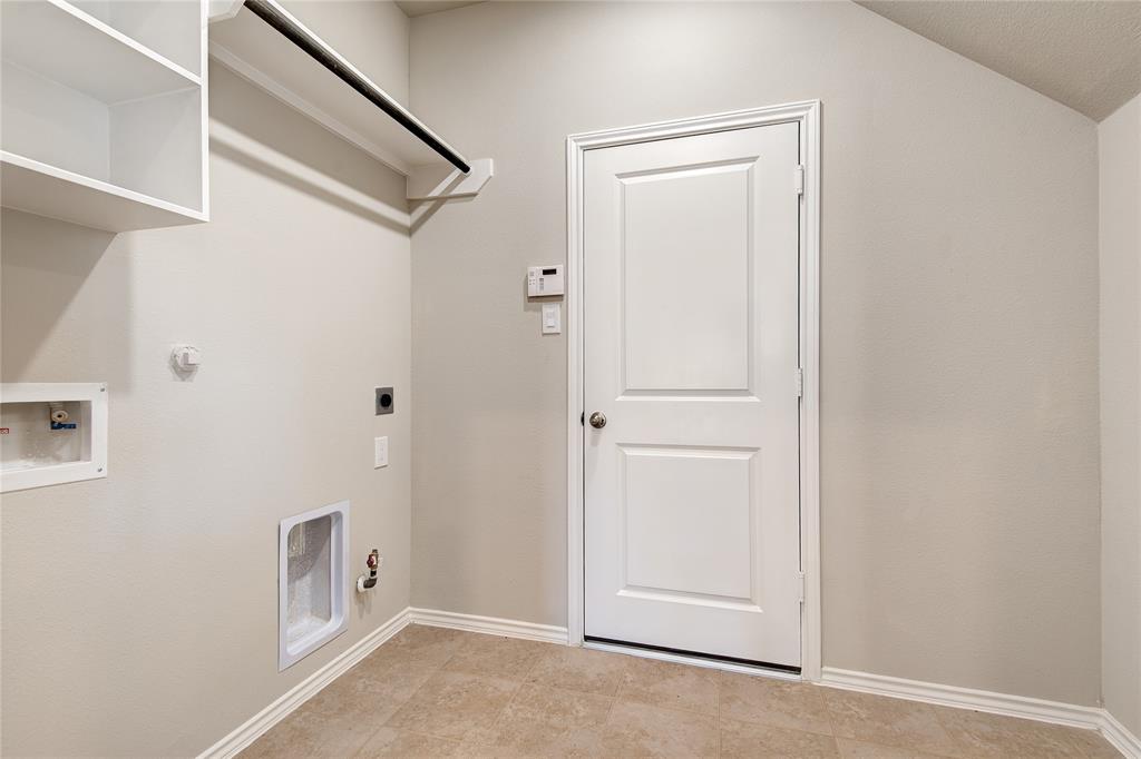 Laundry room is large enough for large family and still has room for a freezer or sewing area.