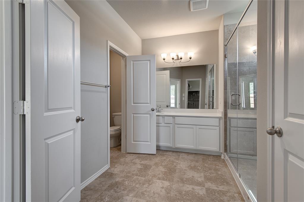 Master bath retreat with extra large walkin shower, elegant tiled floors.