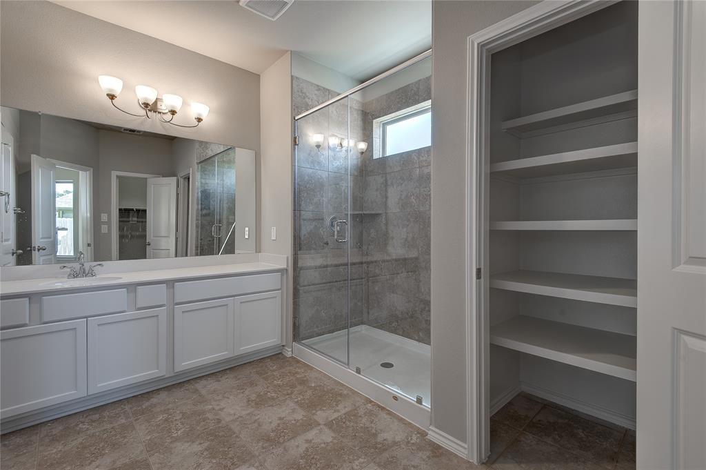 Large linen closet and walk in shower.