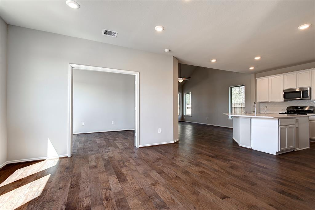 View from front foyer.  Dining area, flex room with double glass pane doors, cook's kitchen with large island that seats 4 or more, walk in pantry, lots of indirect lighting, family room has lots of light opens to the back patio and yard.  The floors are special, aren't they?