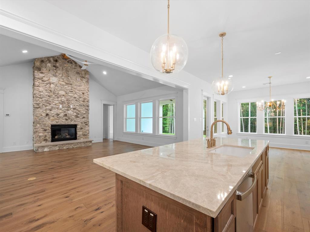Décor lighting, brass kitchen faucet, beautiful Quartzite island with stained accent island perfect for entertaining