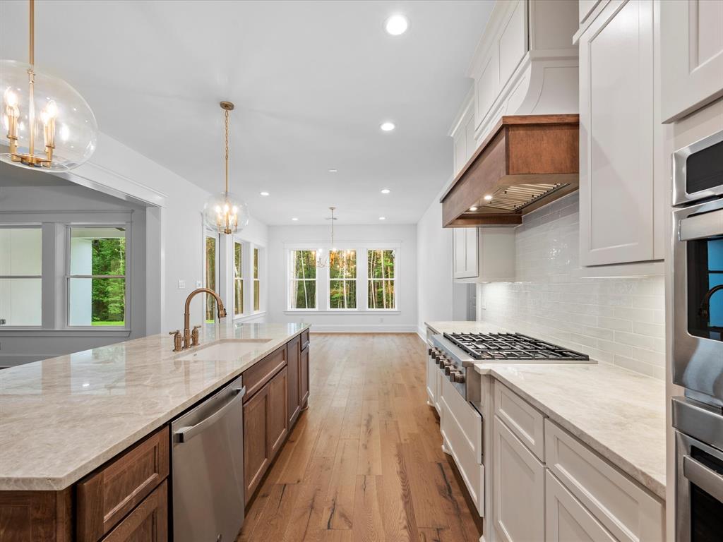 A chef\'s dream, with high-end stainless steel appliances, custom cabinetry, and upscale finishes. The island provides ample counter space for meal prep, while the adjacent dining area is perfect for hosting family and friends.