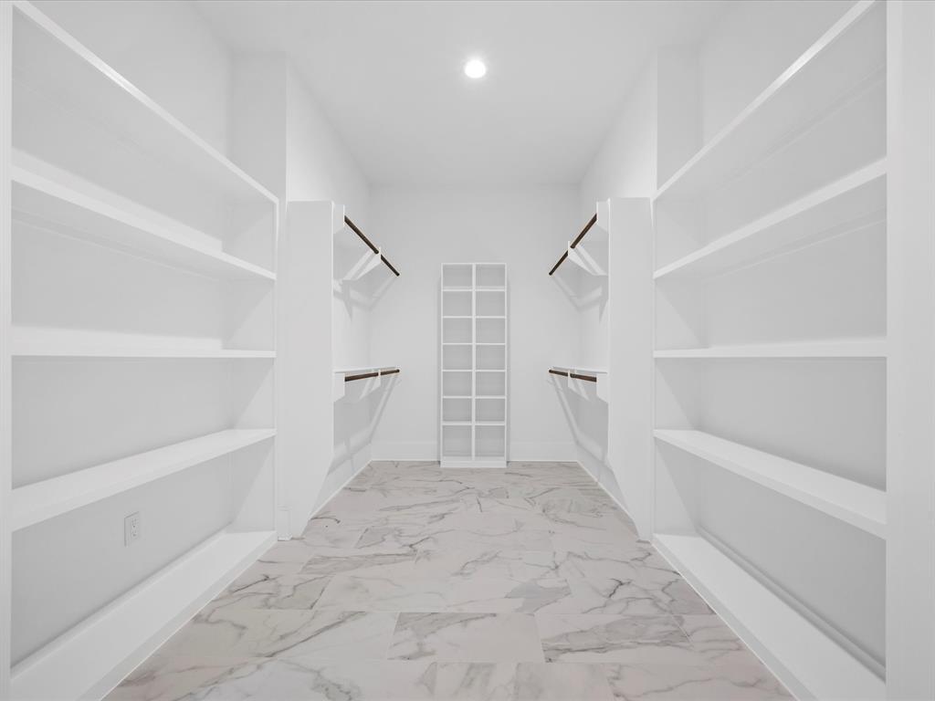Primary closet #1 with built0in storage, hanging space and room to customize according to your needs