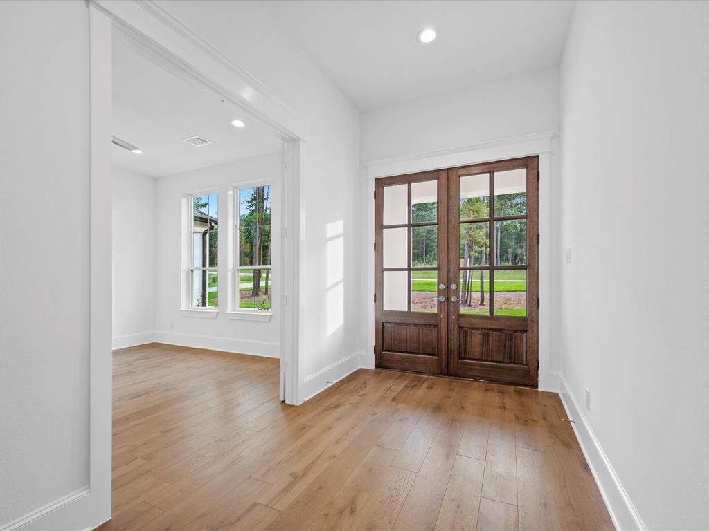 Large foyer with extensive hardwood floors, tons of natural light and crisp white walls and trim perfect for any style of décor