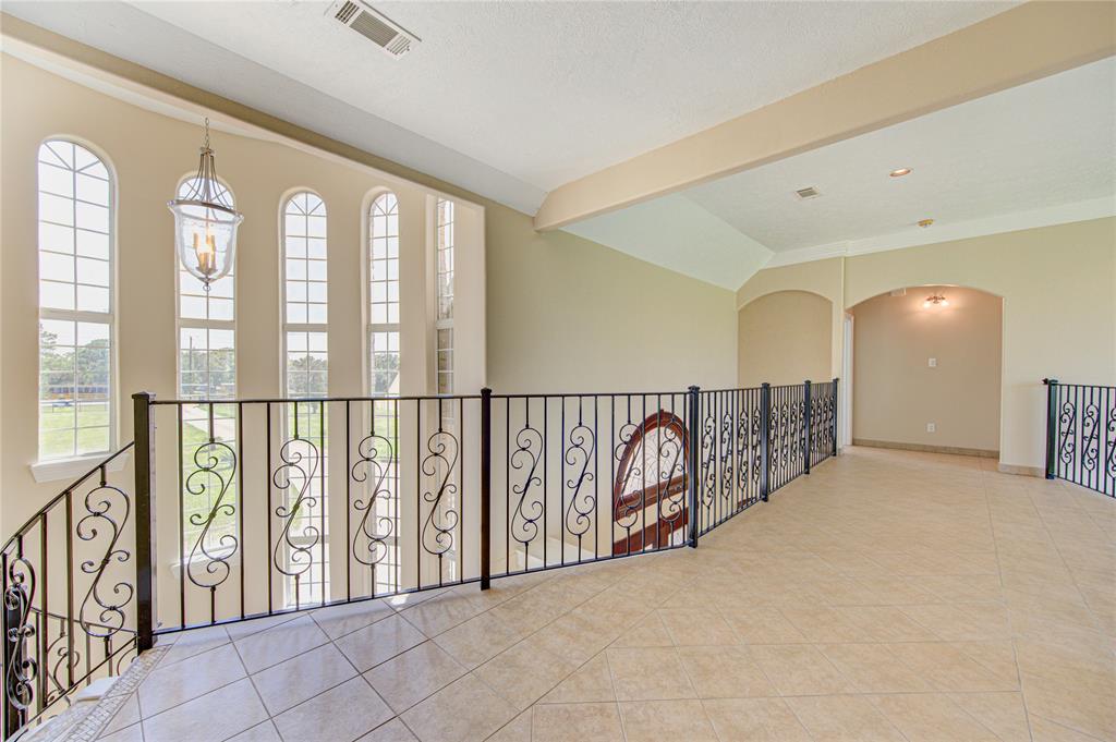 Cross the elegant catwalk to the other wing of the home where you'll find two secondary bedrooms.