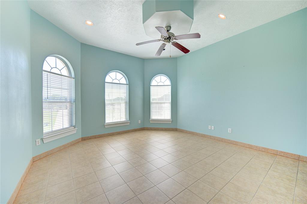 Secondary bedroom also located upstairs offers plenty of natural light.