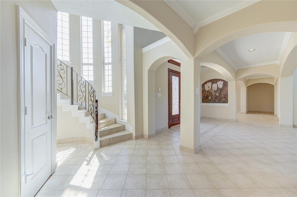 View of entryway. Large storage closet is located under stairs.