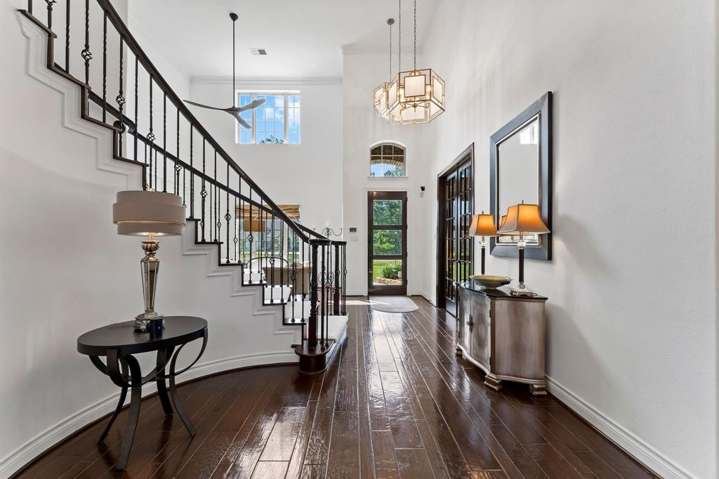 This view is looking at the foyer and new custom solid 3 panel Mahogany front door from the great room.