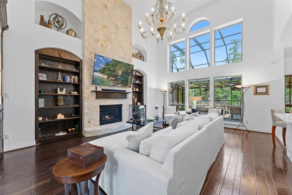 The great room is truly great! Boasting with natural light from the picture windows overlooking the backyard, custom stone fireplace to the ceiling, and the custom hand-blown Murano glass chandelier that can be lowered electronically for maintenance and cleaning.
