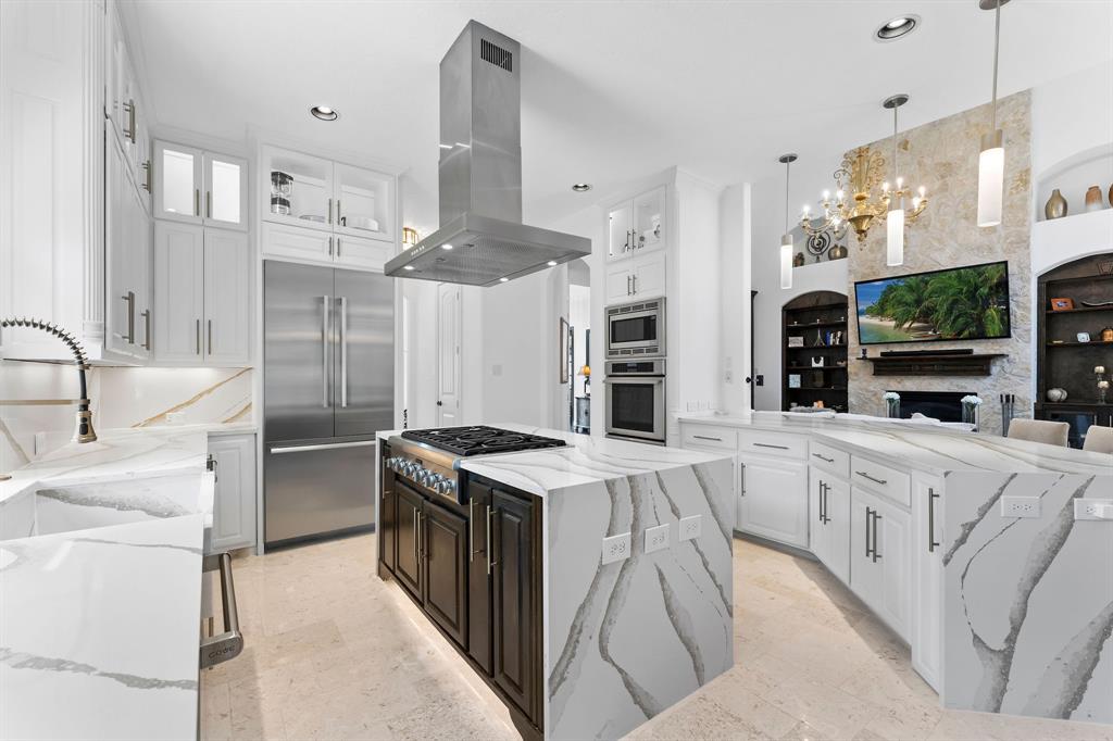 The kitchen is functional and fancy. The Venezia champagne gold quartz counter tops offer ample prep space. The Thermadore appliances included are a 6 burner stove top, double ovens, microwave, an additional steam drawer, and counter depth French doors refrigerator. No need to worry about too many dishes to wash with the 2 Cove dishwashers on either side of the sink.