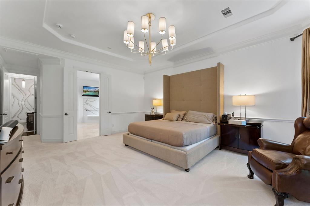 The carpet in the primary, on the stairs, and upstairs is Mohawk Luxury SmartStrand Silk Reserve Carpet making it soft, durable and easy to clean. The room is completed by another designer upgraded chandelier.