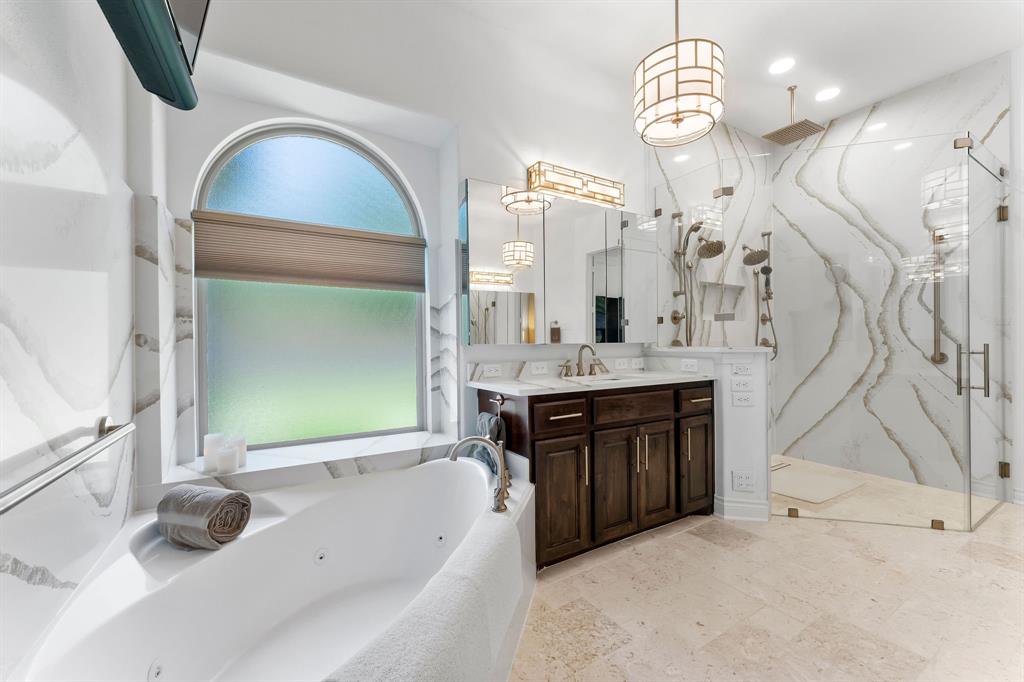 The walk in shower features 5 shower heads. The luxury rainfall shower head, 2 individual sprayers and 2 individual shower heads are individually controlled for your desired temperature and flow rate resulting in a true spa experience. An extra long linear drain lines the shower floor.