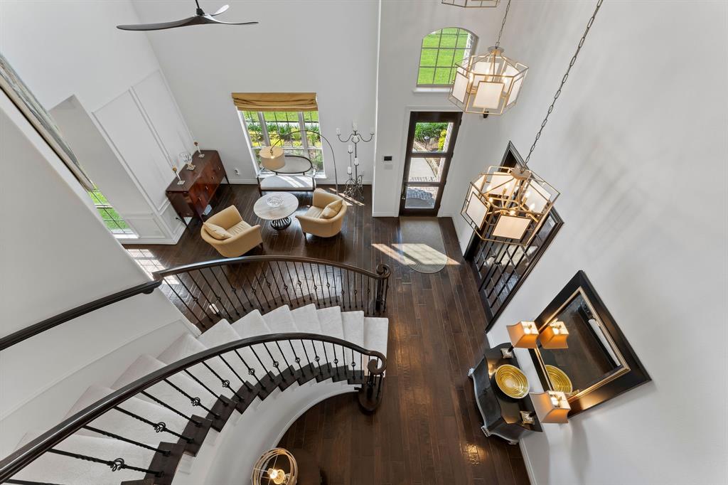 A view of the foyer from upstairs demonstrating the 3 Daisy chain chandeliers.
