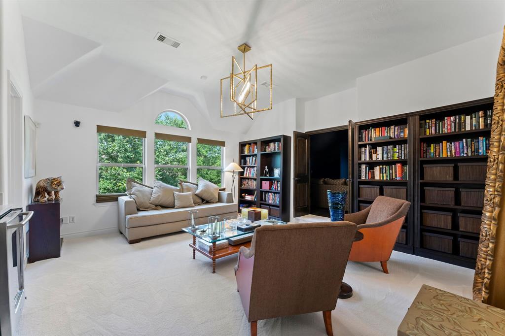 The library upstairs is a great space for an additional living area, play room, or work out room and features a beautiful designer light fixture. A half bathroom is located to the left.