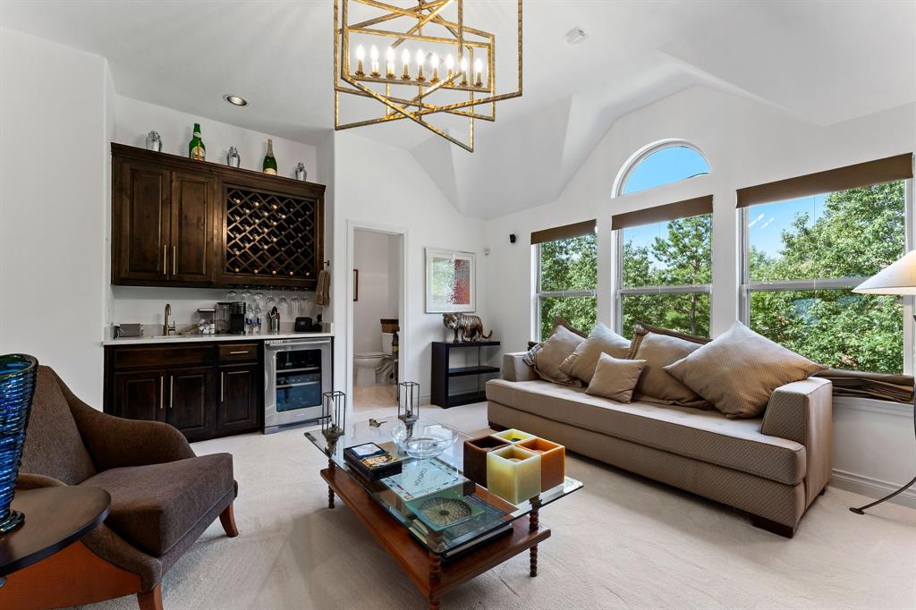 The theme of the home continues throughout with luxury lighting in every room and quartz counters in the wet bar. The Electrolux wine fridge will stay with the home.