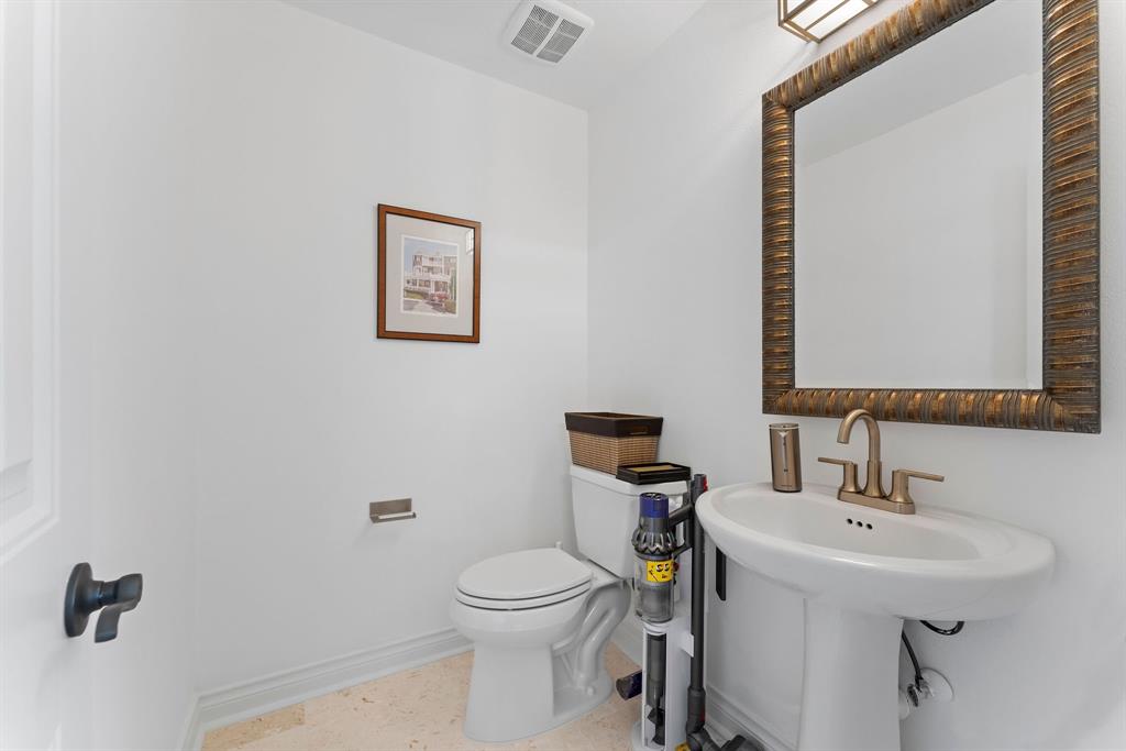 The upstairs half bathroom is conveniently located off the game room.
