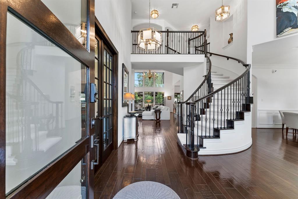 A gorgeous curved staircase and 2 story foyer welcome you inside. The home features hard wood floors throughout the main living areas downstairs, designer upgraded lighting in every room and most closets, Venezia champagne gold quartz throughout the entire home, and upgraded 8 foot interior doors.