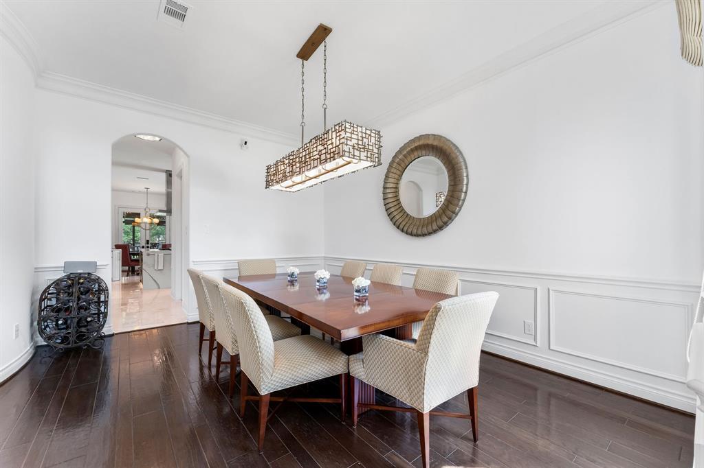 The formal dining room is large enough for a dinner party, features a luxurious dining room light fixture centered to the room, and has convenient access to the kitchen. The huge walk in pantry and laundry room are tucked on each side of the walkway between the dining room and kitchen.