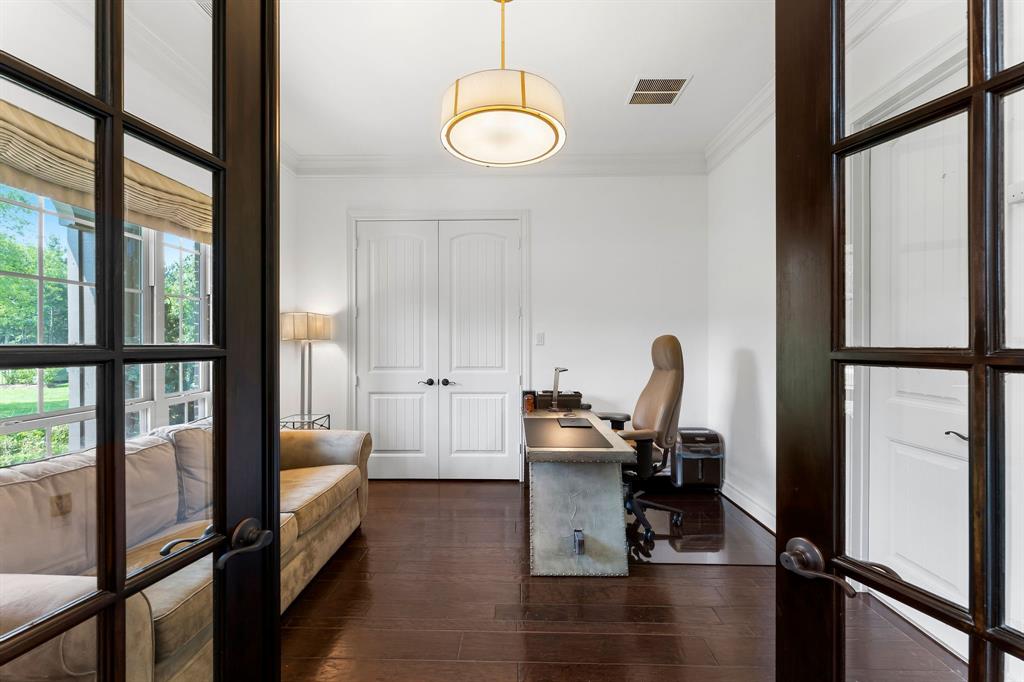 The private home office is located behind double 18-panel glass doors off the foyer. The office has a great view of the front lawn, designer upgraded light fixture and an en-suite bathroom.