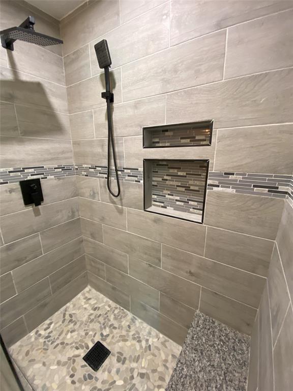 Beautiful Tiled Shower with seating and dual showerheads