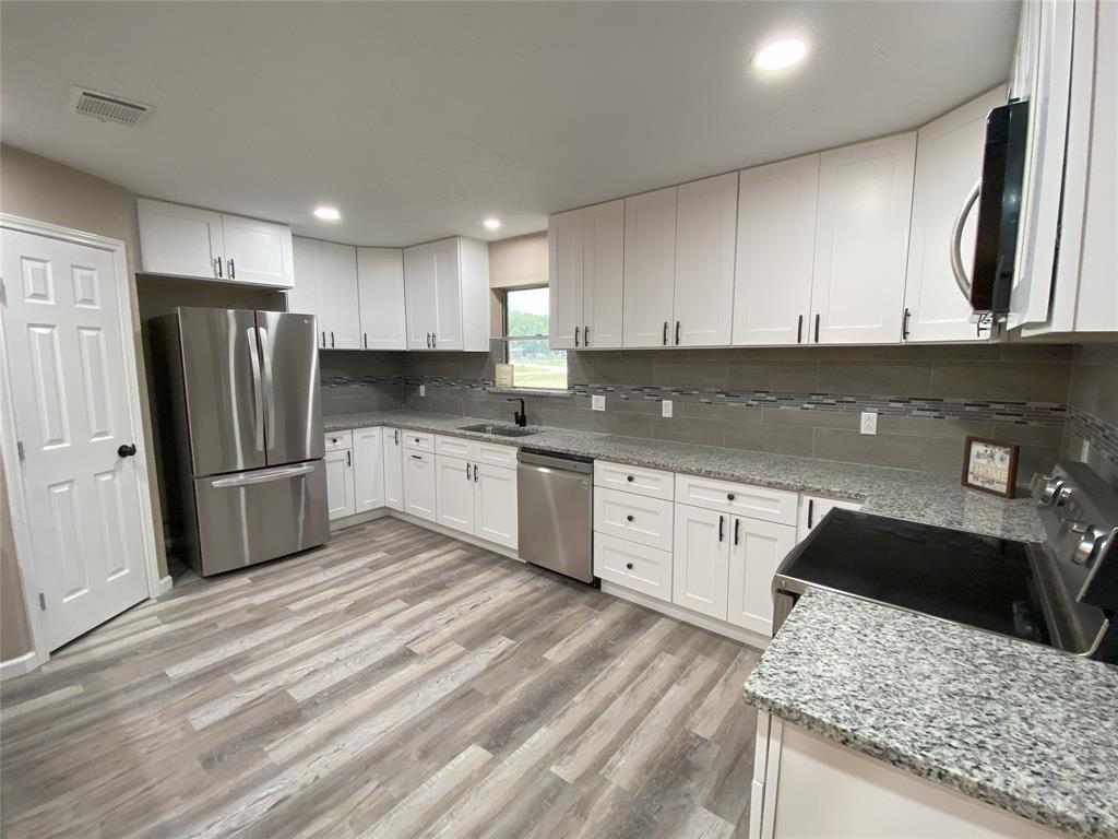 Large Kitchen with Lots of Soft Closing Cabinets and Drawers. All New SS Appliances. New Granite with beautiful tiled backsplash. Large Pantry.