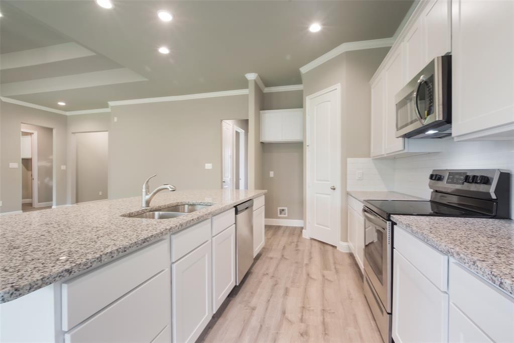 Granite countertops and stainless steel appliances in the kitchen.