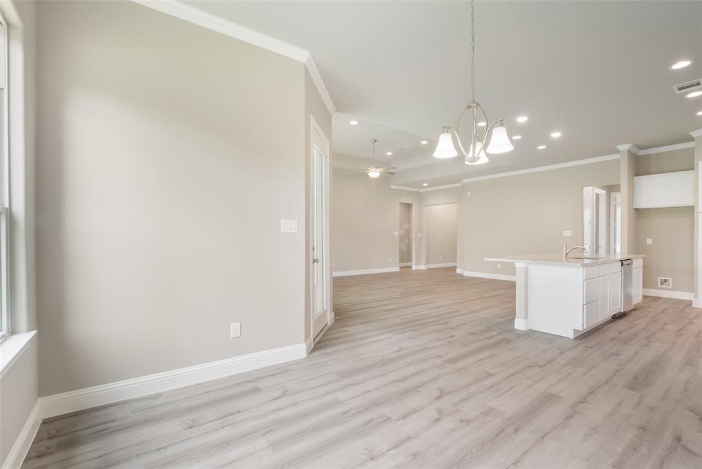 A view from the breakfast/dining area looking towards kitchen and main living area.