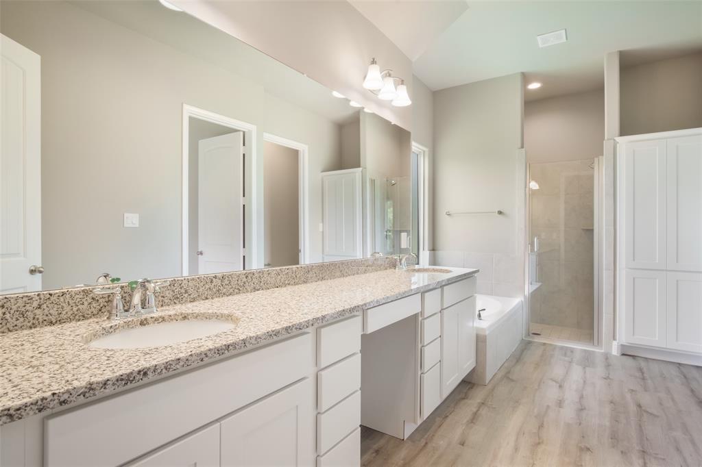 Separate shower next to garden style tub in primary bath.