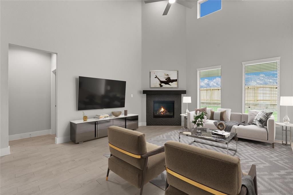 Gather the family and guests together in your lovely living room! Featuring high ceilings, recessed lighting, ceiling fan, custom paint, gorgeous floors, fireplace with mantel and large windows that provide plenty of natural lighting throughout the day.