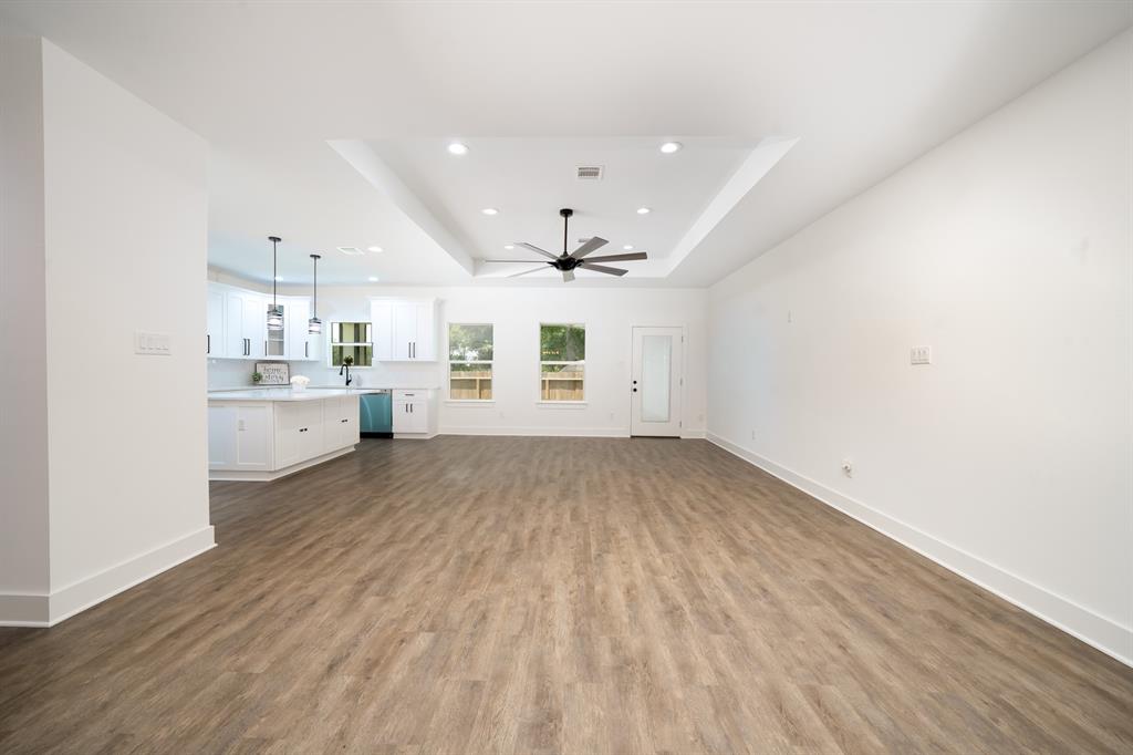 Open floor plan flows to kitchen and dining room