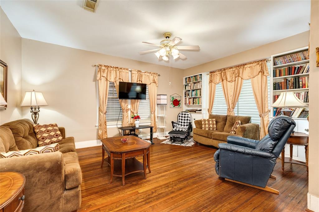 This living room is large and offers large windows and room for a crowd