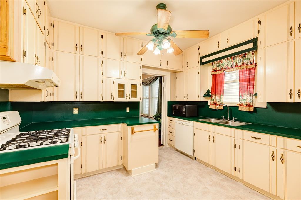 The vintage kitchen is filled with cabinet storage and ample counter space.