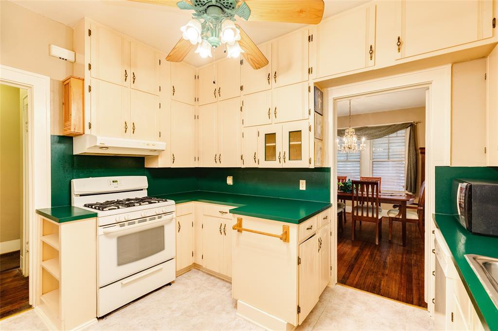 Gas stove, a built-in bread box, and plenty of space in this vintage kitchen.