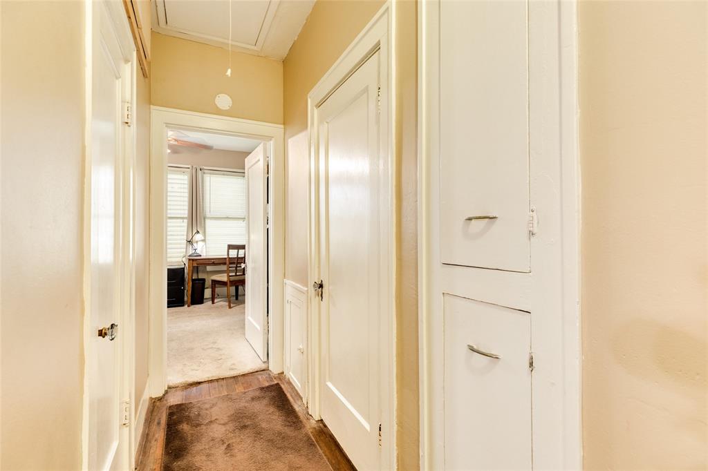 The long hallway runs between the bedrooms and these doors are for closets and the bathroom. Notice the closet cabinets in the foreground, this space could easily be taken into the bathroom to enlarge that space if desired.