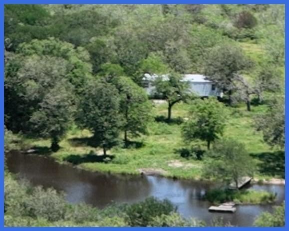 Unrestricted 10.1 ac tract between Katy and San Antonio. Older 3/2 mobile home, clean inside. Well and septic in place. Large pond. Selling AS-IS. Seller will order survey, fence and install entry gate. No minerals convey. Part of larger tract.